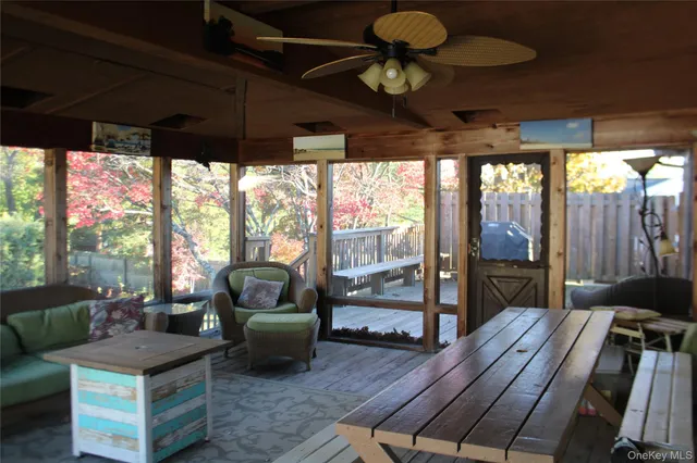 a living room with furniture and a floor to ceiling window