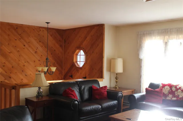 a living room with furniture and a lamp