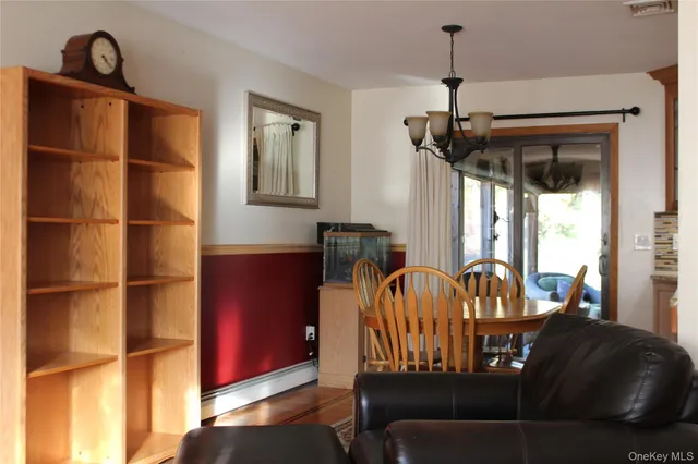 a living room with furniture a flat screen tv and a window