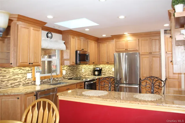 a kitchen with sink refrigerator and microwave
