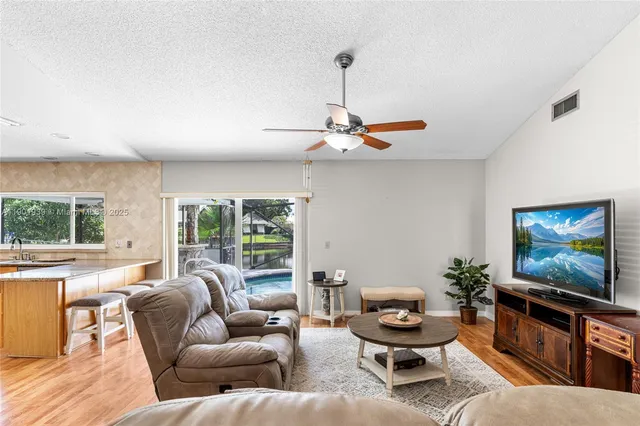 a living room with furniture a window and a flat screen tv