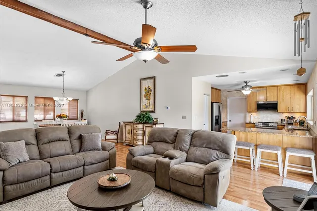 a living room with furniture a rug and a chandelier