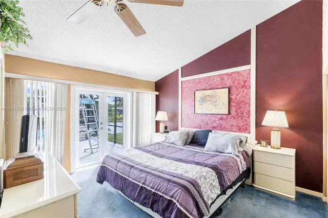 a bedroom with a large bed and a large window