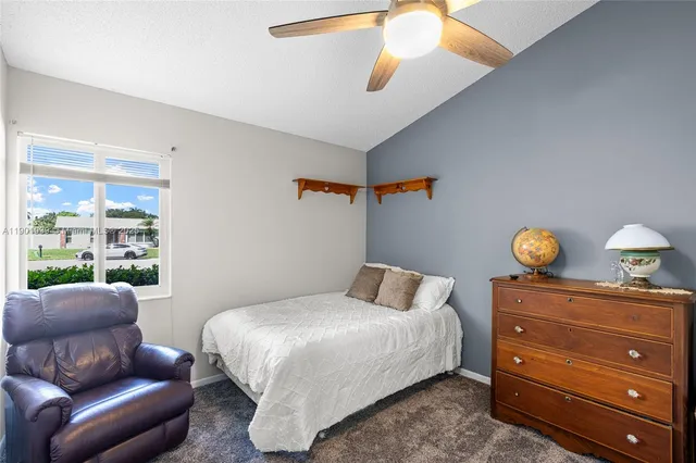 a bedroom with a bed window and couch