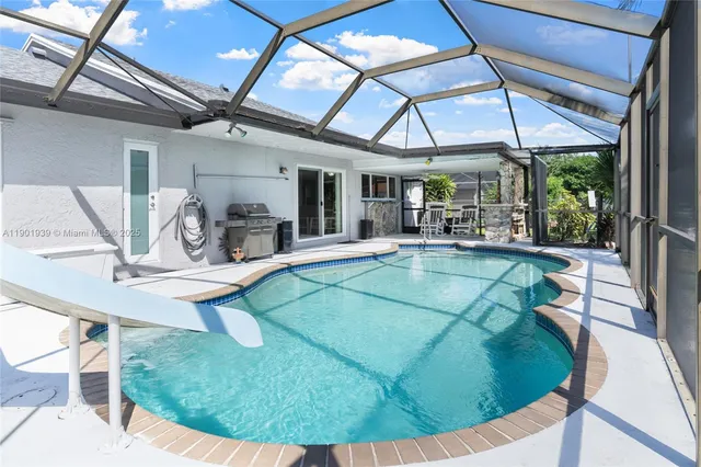 a view of a swimming pool with chairs in patio