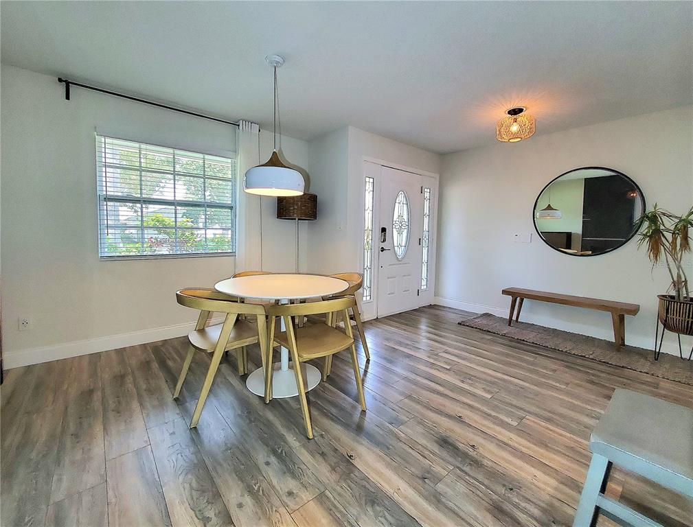 6522 Hidden Beach Circle Orlando, FL 32819 - Photo 11 of 65 a living room with a table chairs and a dining table