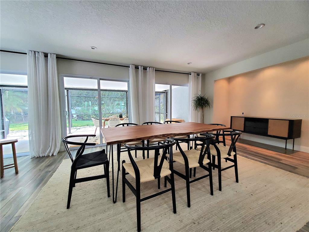 6522 Hidden Beach Circle Orlando, FL 32819 - Photo 19 of 65 a view of a dining room with furniture window and wooden floor