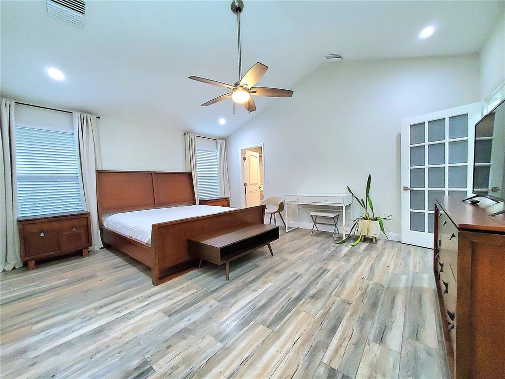 6522 Hidden Beach Circle Orlando, FL 32819 - Photo 27 of 65 a bedroom with furniture and a wooden floor