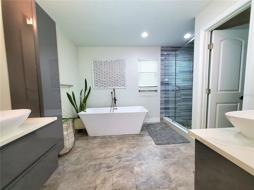 6522 Hidden Beach Circle Orlando, FL 32819 - Photo 28 of 65 a bathroom with a bathtub and shower