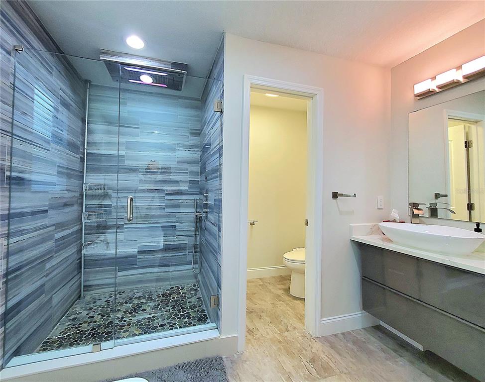 6522 Hidden Beach Circle Orlando, FL 32819 - Photo 29 of 65 a bathroom with a sink and a mirror