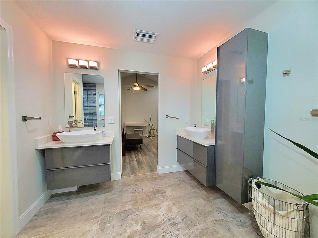 6522 Hidden Beach Circle Orlando, FL 32819 - Photo 31 of 65 a bathroom with a double vanity sink mirror and bathtub