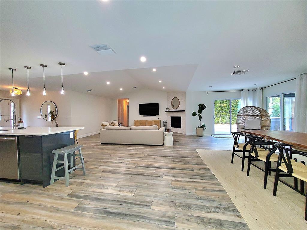 6522 Hidden Beach Circle Orlando, FL 32819 - Photo 34 of 65 a living room with furniture a table and kitchen view