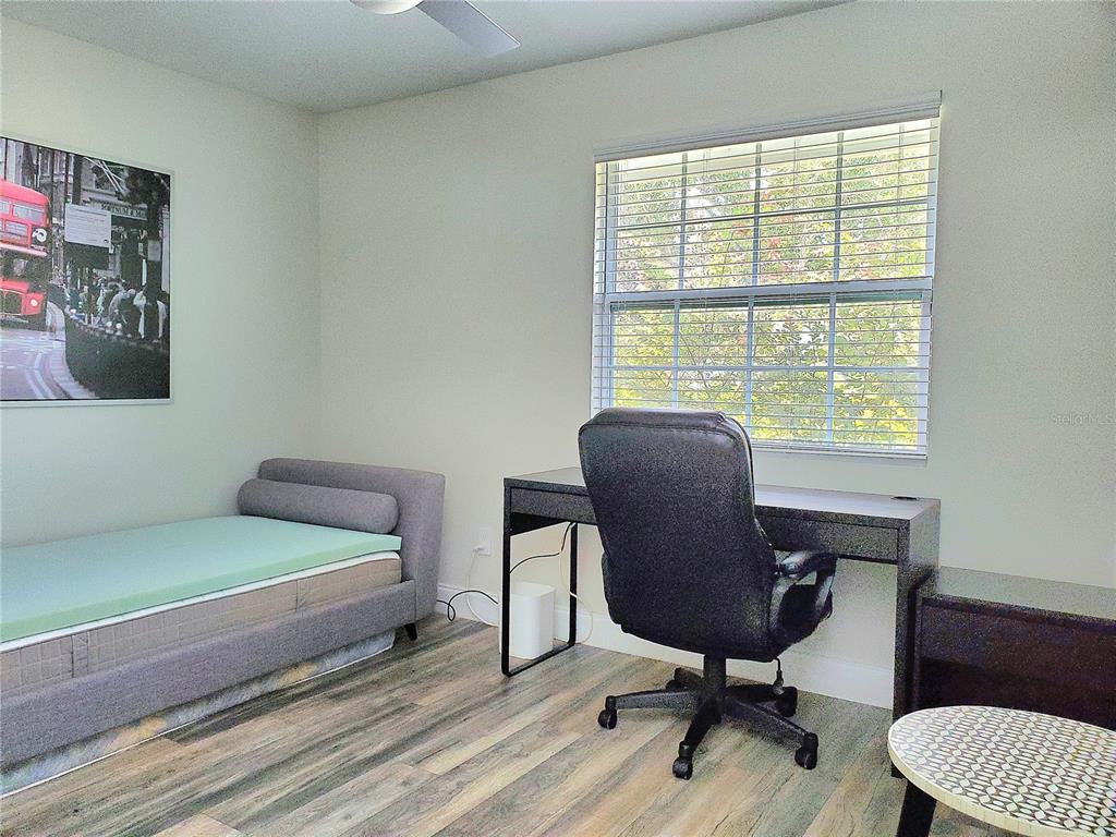 6522 Hidden Beach Circle Orlando, FL 32819 - Photo 41 of 65 a bedroom with a bed and a chair