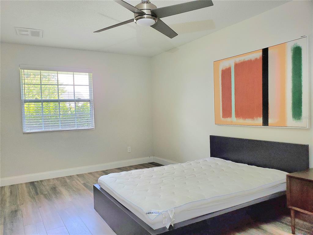 6522 Hidden Beach Circle Orlando, FL 32819 - Photo 42 of 65 a bed sitting in a bedroom next to a window