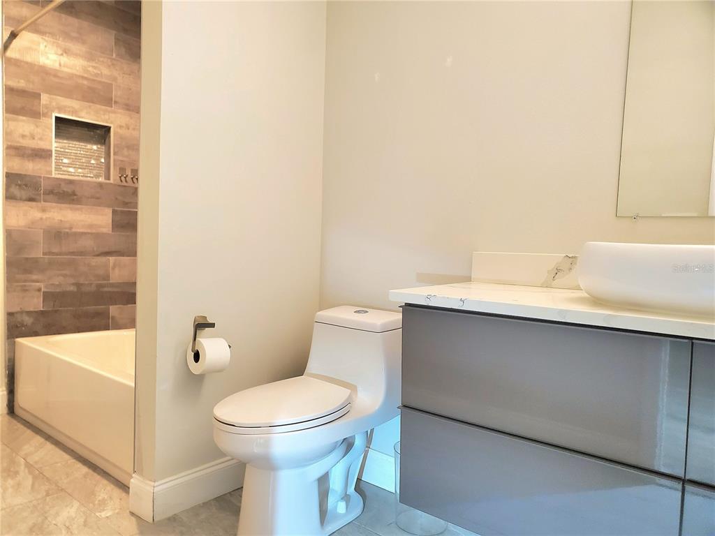 6522 Hidden Beach Circle Orlando, FL 32819 - Photo 44 of 65 a white toilet sitting next to a bathroom sink