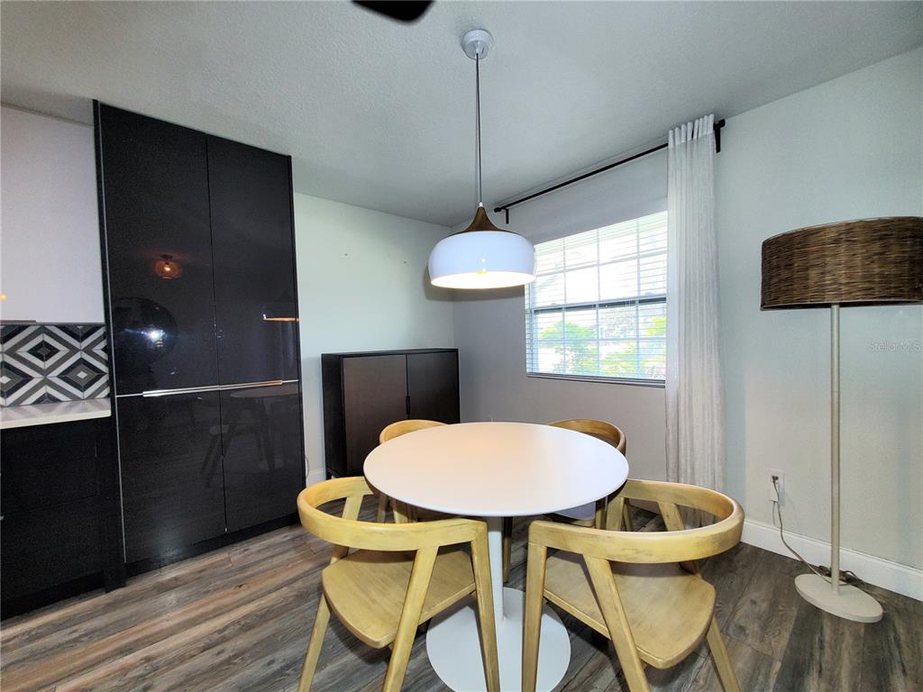 6522 Hidden Beach Circle Orlando, FL 32819 - Photo 5 of 65 a view of a dining room with furniture window and wooden floor