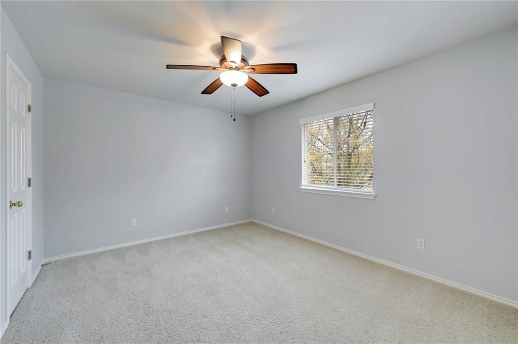 932 Rusk Road Round Rock, TX 78665 - Photo 30 of 33 bedroom 2 - ceiling fan & walk-in closet.