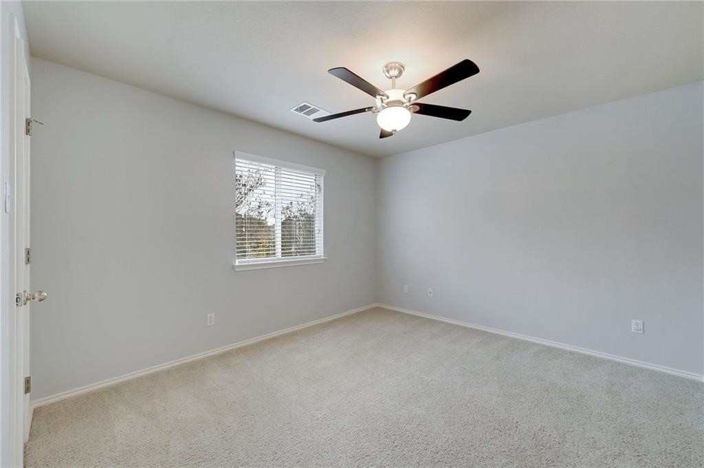 932 Rusk Road Round Rock, TX 78665 - Photo 32 of 33 bedroom 3 - ceiling fan & walk-in closet.