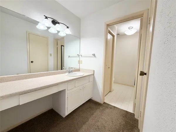 a spacious bathroom with a double vanity sink and a mirror