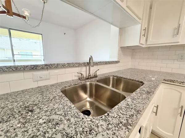 a kitchen with a sink and cabinets