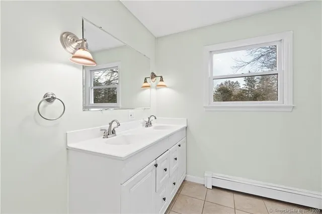 a bathroom with a granite countertop sink a toilet and a bathtub