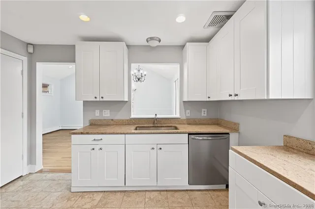 a kitchen with stainless steel appliances granite countertop a sink and cabinets