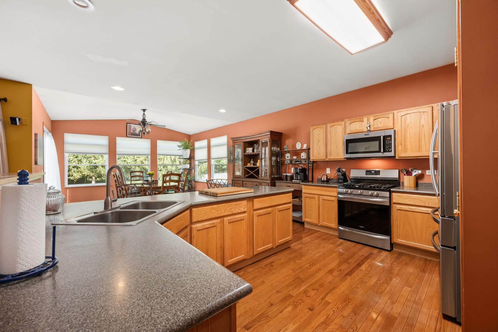 214 Stearn Drive Genoa, IL 60135 - Photo 18 of 24 a kitchen with stainless steel appliances granite countertop a stove a sink and a microwave