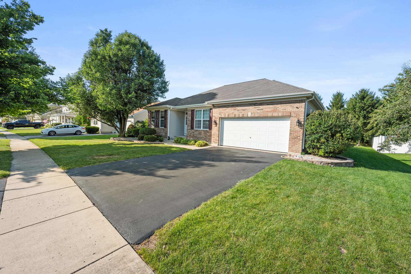 214 Stearn Drive Genoa, IL 60135 - Photo 2 of 24 a front view of a house with a yard and garage