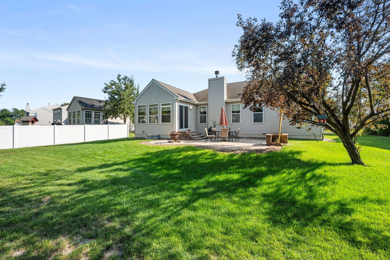 214 Stearn Drive Genoa, IL 60135 - Photo 22 of 24 a view of an house with backyard and a tree