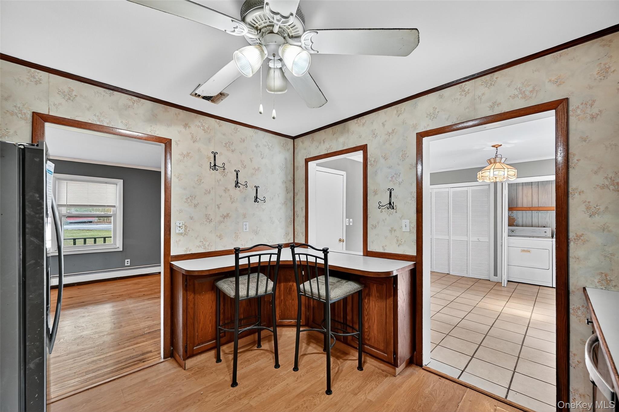 8 Haight Road Monroe, NY 10950 - Photo 16 of 40 ornamental molding, washer / dryer, light wood-style flooring, and baseboard heating