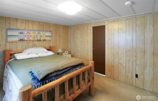 a bedroom with a bed and large window