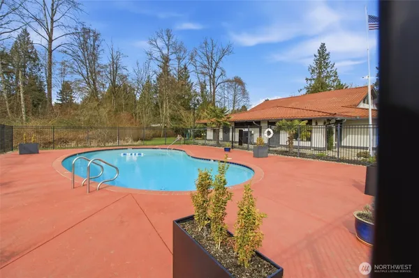 a view of a swimming pool with an outdoor space and seating area