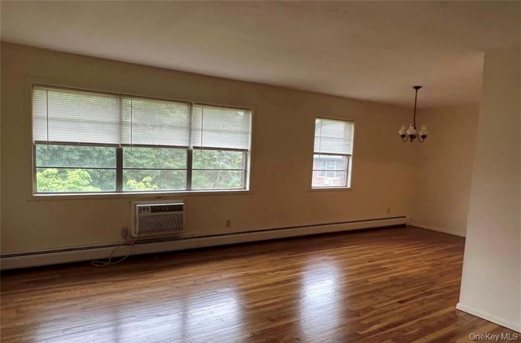 65 Curie Road, Unit F8 Cornwall-on-Hudson, NY 12520 - Photo 3 of 9 an empty room with wooden floor and windows