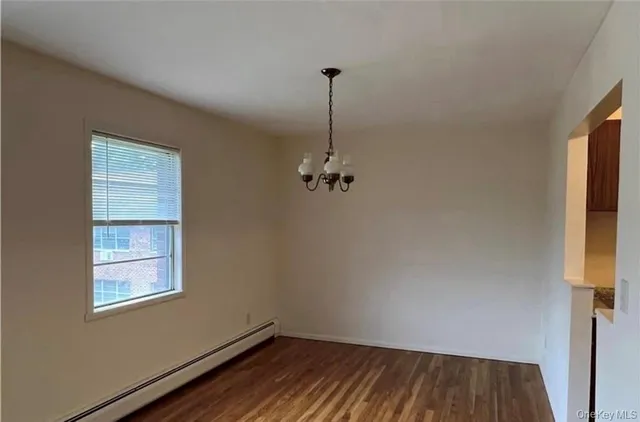 a view of a room with wooden floor cabinet and a window