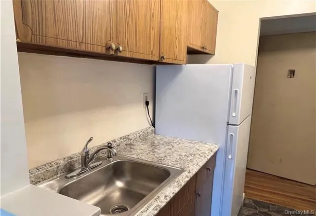 a kitchen with a sink and a refrigerator