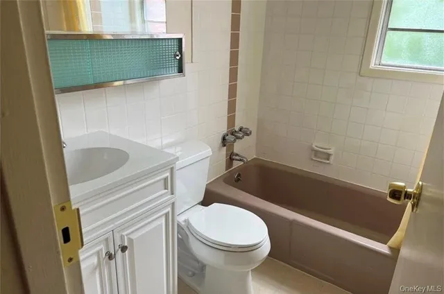 a bathroom with a sink a toilet and bathtub