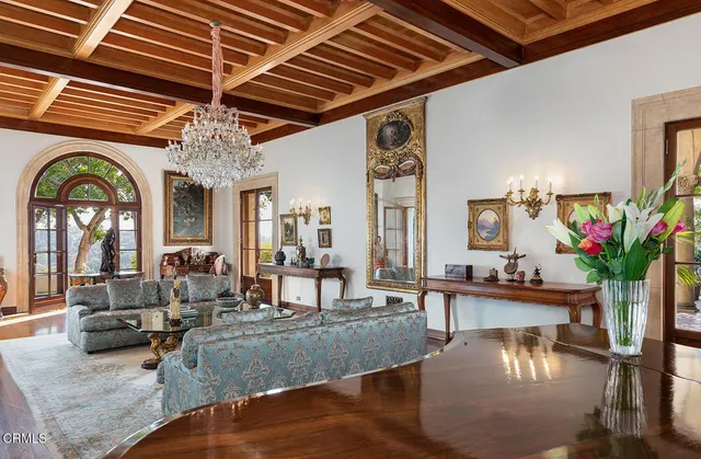 a living room with furniture a fireplace and a table