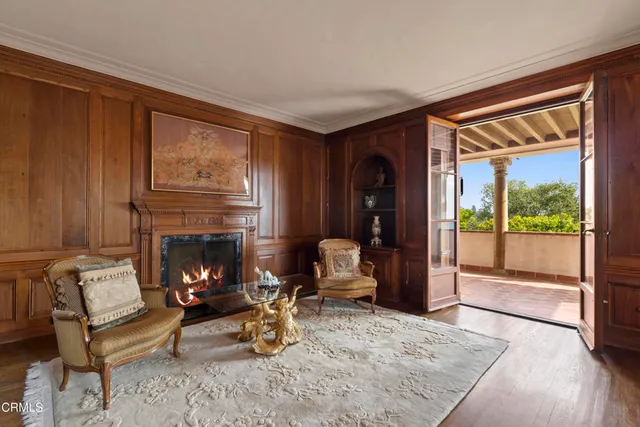 a spacious bedroom with a bed a chandelier and dresser