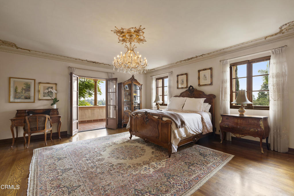 262 South San Rafael Avenue Pasadena, CA 91105 - Photo 35 of 49 a spacious bedroom with a bed a chandelier and dresser