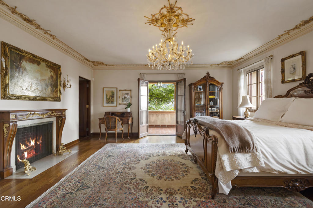 262 South San Rafael Avenue Pasadena, CA 91105 - Photo 36 of 49 a spacious bedroom with a bed and a fireplace