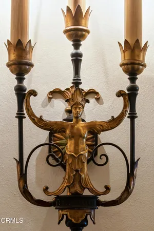 a view of a hallway with wooden floor and a chandelier