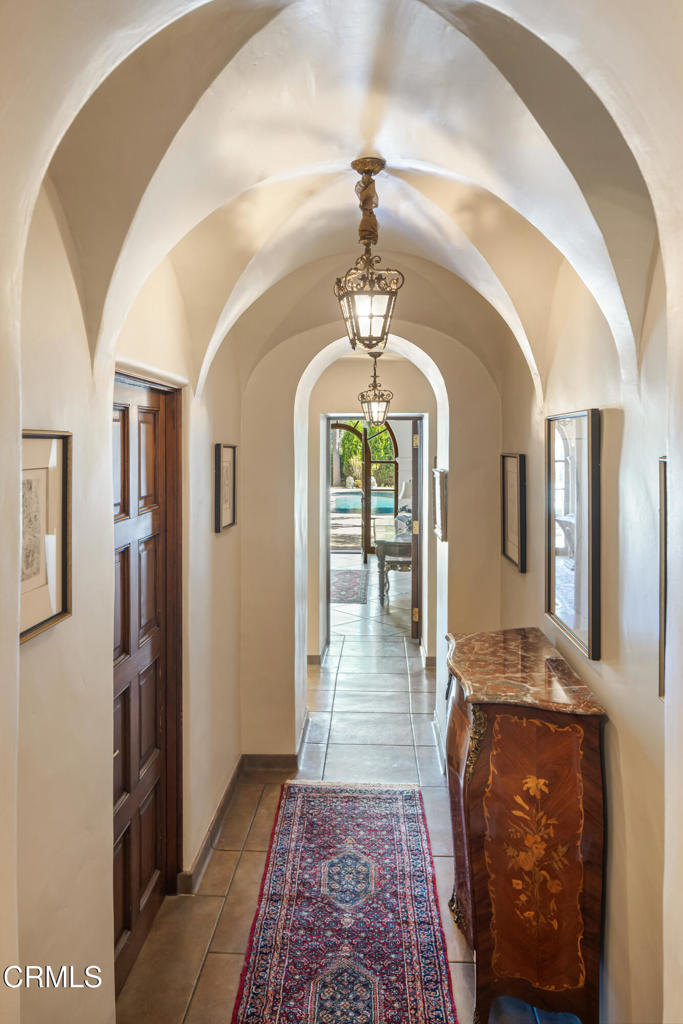 262 South San Rafael Avenue Pasadena, CA 91105 - Photo 39 of 49 a view of a hallway with wooden floor and a chandelier
