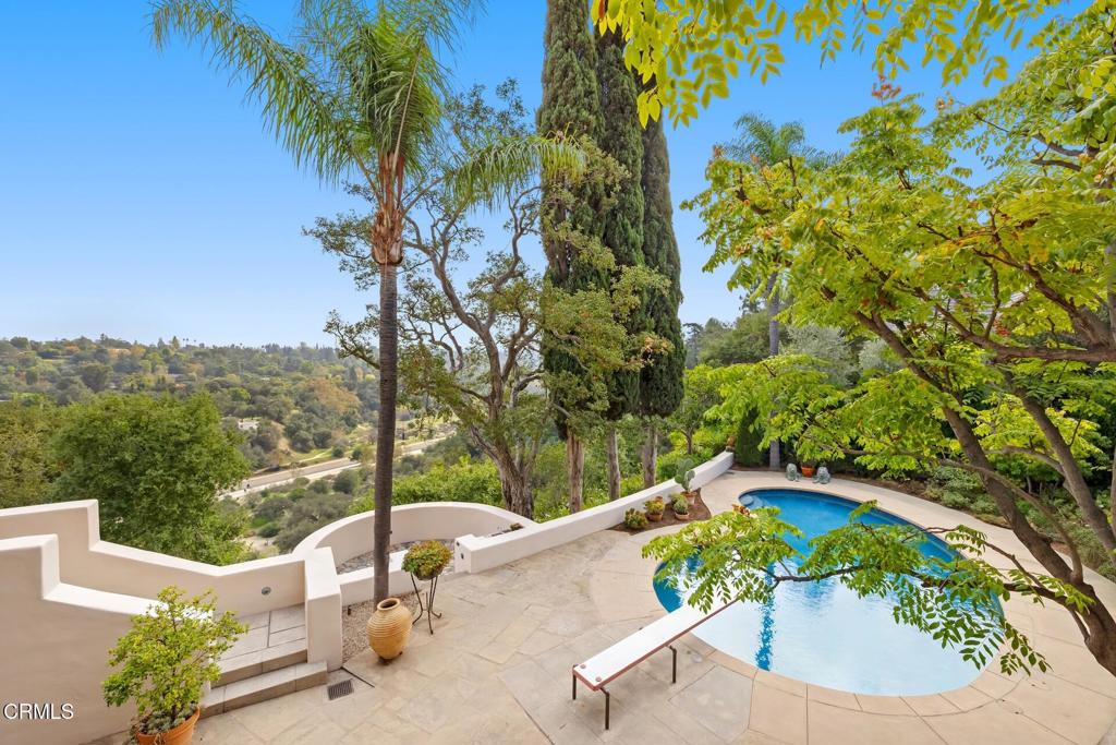 262 South San Rafael Avenue Pasadena, CA 91105 - Photo 43 of 49 a view of a swimming pool with a patio and a garden