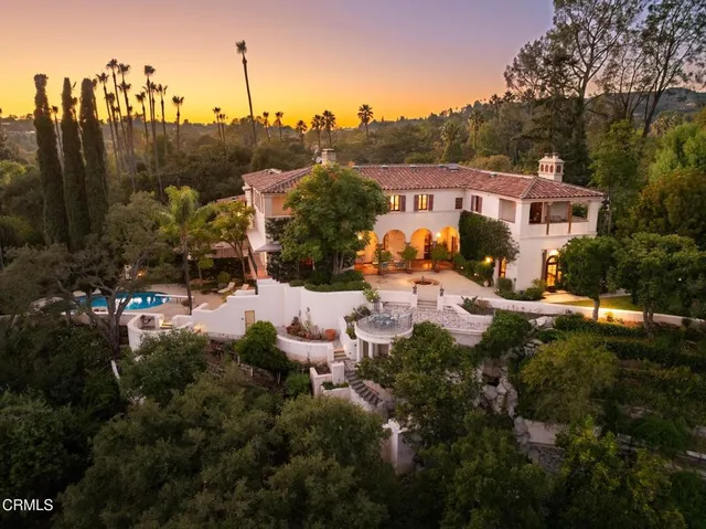 a view of a house with a yard and sitting area