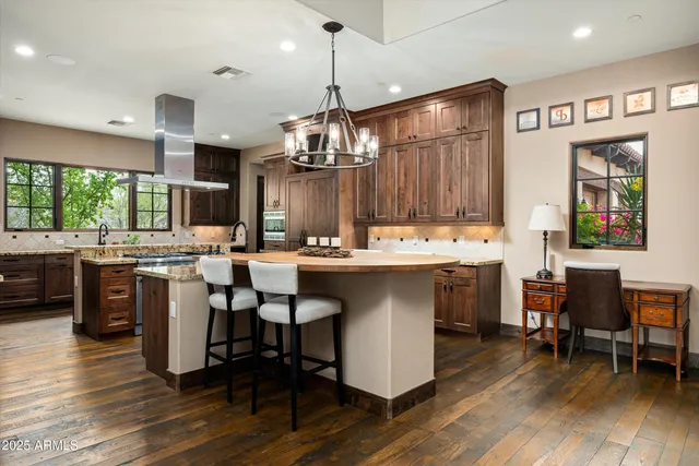 a kitchen with a sink cabinets and wooden floor