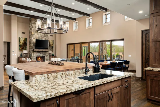 a kitchen with granite countertop a sink and a refrigerator