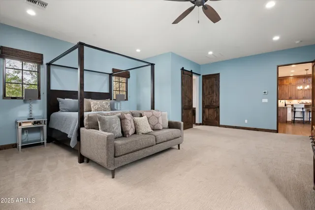 a living room with furniture and a ceiling fan