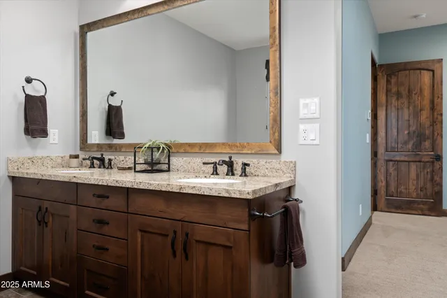 a bathroom with a granite countertop sink and a mirror