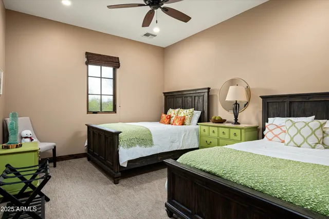 a bedroom with 2 bed and a chandelier