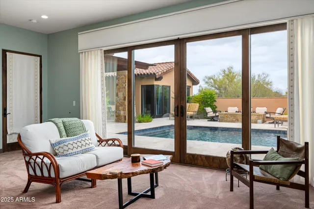 a living room with furniture and a floor to ceiling window